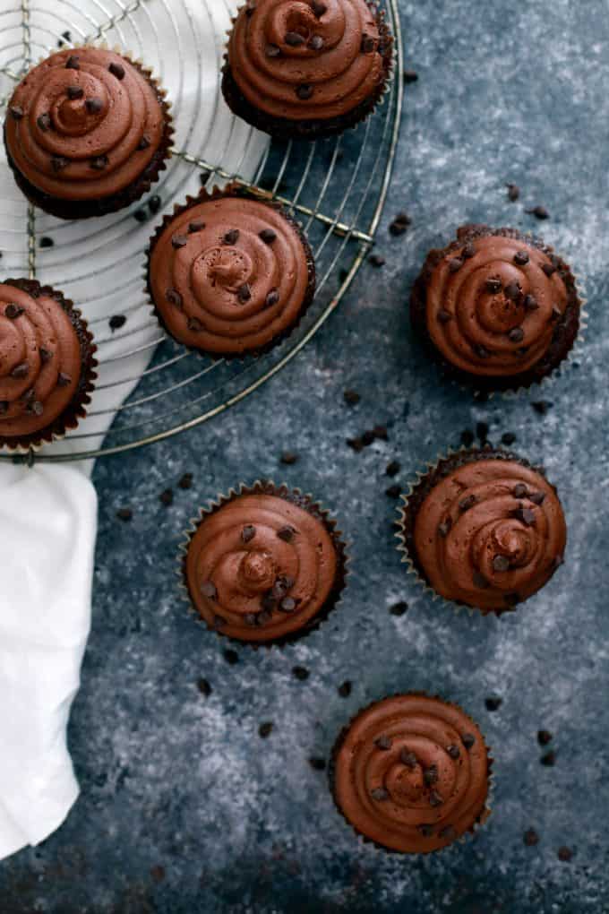 These Chocolate Chocolate Chip Zucchini Cupcakes are incredibly dreamy and you shouldn't go another minute without them in your life. A moist and decadent chocolate cupcakes is studded with chocolate chips and flecked with zucchini before being topped with a swirling mountain of my Dark Chocolate Buttercream Frosting and mini chocolate chips.