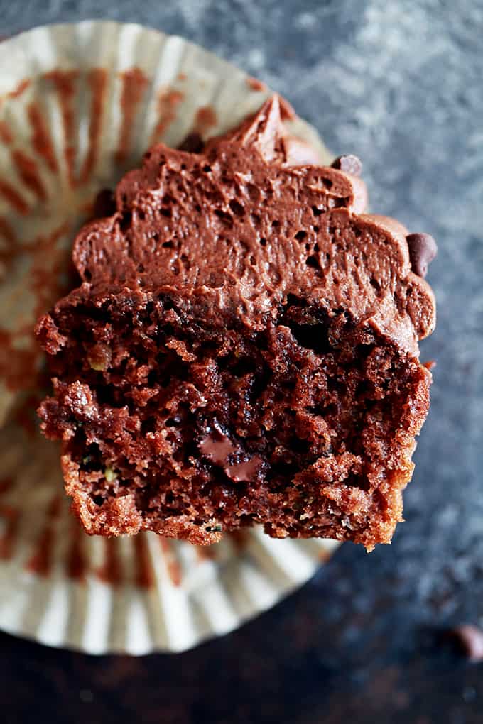 These Chocolate Chocolate Chip Zucchini Cupcakes are incredibly dreamy and you shouldn't go another minute without them in your life. A moist and decadent chocolate cupcakes is studded with chocolate chips and flecked with zucchini before being topped with a swirling mountain of my Dark Chocolate Buttercream Frosting and mini chocolate chips.