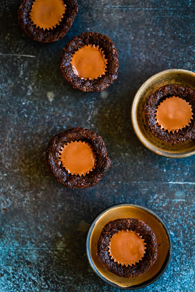 Two Peanut Butter Cup Brownie Bites in mini bowls with three other desserts alongside.