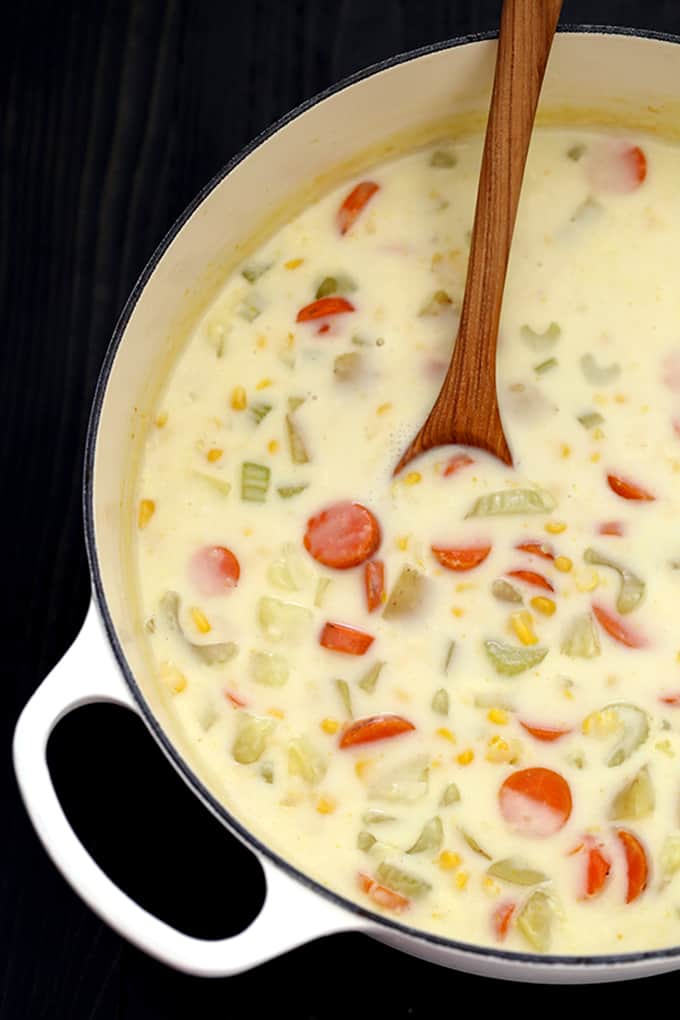 Carrots, potatoes and celery are stirred together with a creamy, comforting rue and corn to create a quick and easy Potato Corn Chowder.  Each bowl is garnished with additional corn, green onions and cheddar cheese to provide a contrast in texture that keeps you returning to your bowl for just one bite.