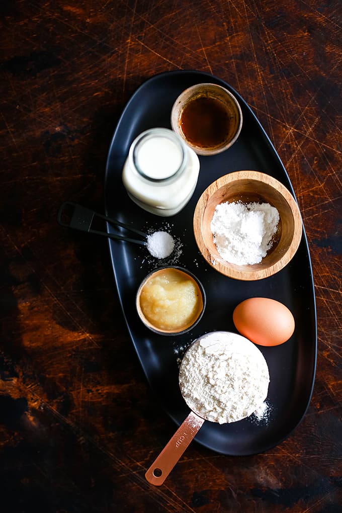 All of the ingredients needed to prepare the Best Buttermilk Pancakes on a black tray.
