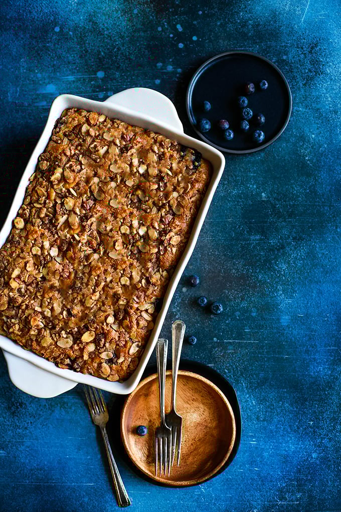 An overhead view of a white casserole dish of Blueberry Lemond Almond Coffee Cake.