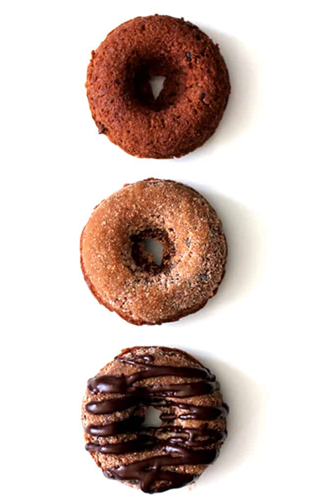 These Triple Chocolate Snickerdoodle Donuts are a perfect treat any time of day!  A dreamy combination of part breakfast treat, part cookie.  A cocoa and cinnamon infused donut studded with chocolate chips, dusted in cinnamon sugar and then drizzled with dark chocolate.   
