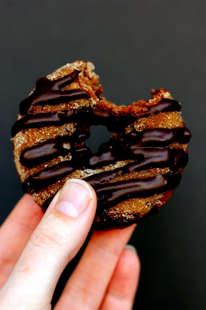 These Triple Chocolate Snickerdoodle Donuts are a perfect treat any time of day!  A dreamy combination of part breakfast treat, part cookie.  A cocoa and cinnamon infused donut studded with chocolate chips, dusted in cinnamon sugar and then drizzled with dark chocolate.   