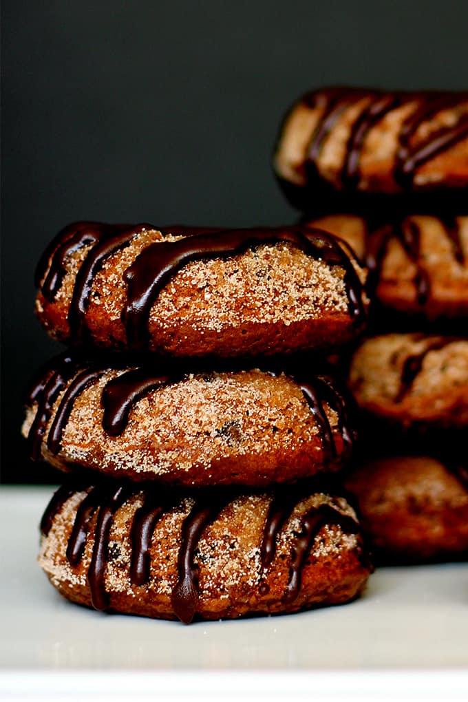 These Triple Chocolate Snickerdoodle Donuts are a perfect treat any time of day!  A dreamy combination of part breakfast treat, part cookie.  A cocoa and cinnamon infused donut studded with chocolate chips, dusted in cinnamon sugar and then drizzled with dark chocolate.   