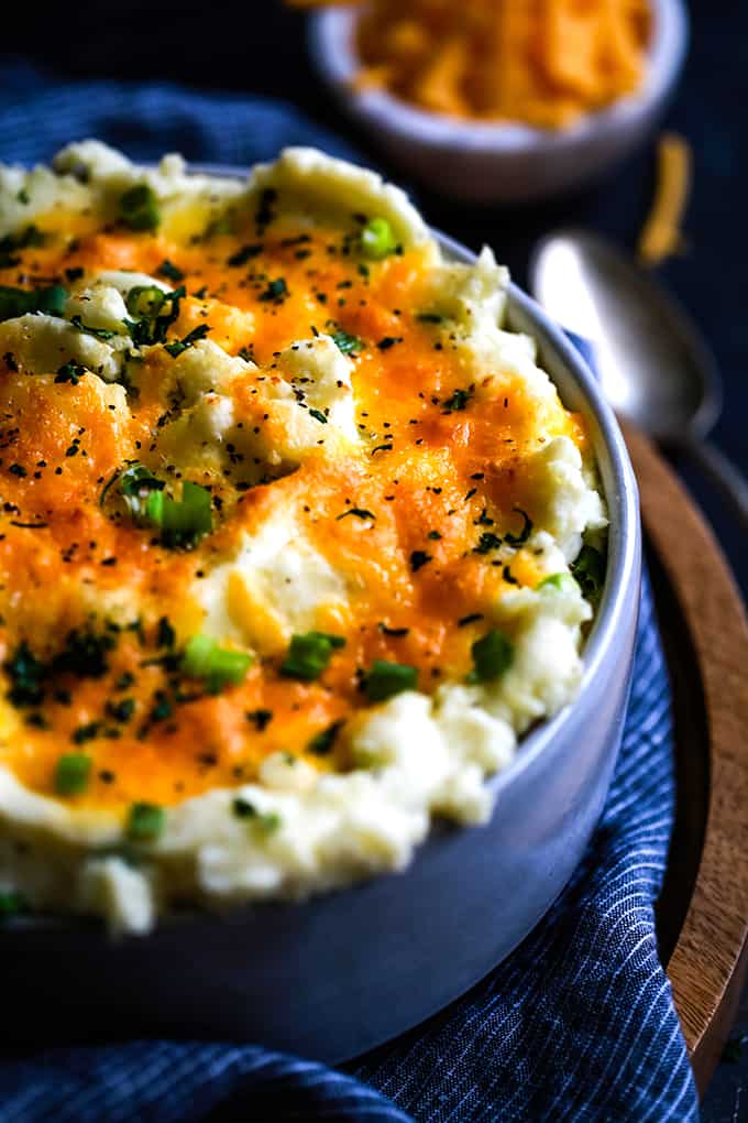Make Ahead Aunt Ruthie Mashed Potatoes in a bowl sitting on a striped napkin.