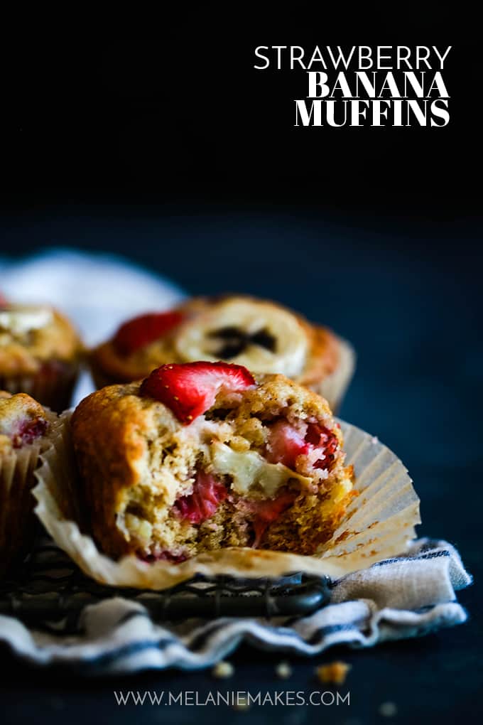 Four Strawberry Banana Muffins with a bite removed from one muffin.