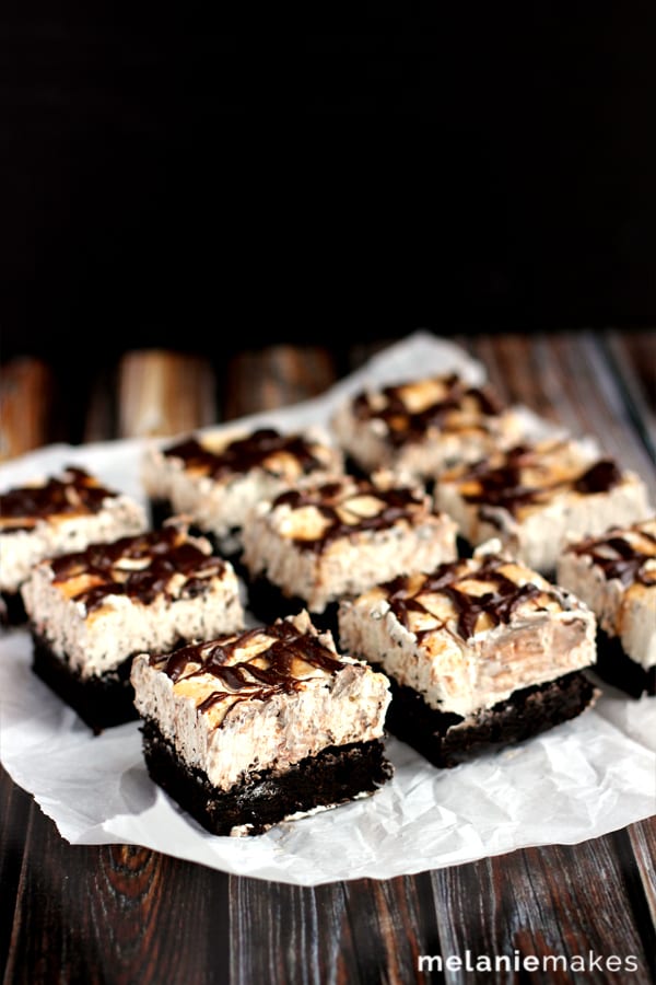 These Snickerdoodle Cheesecake Brownie Bars are the delicious combination of three different desserts. A rich, soft brownie is the base for a cinnamon cheesecake that is then topped with caramel, chocolate ganache and a dusting of cinnamon.