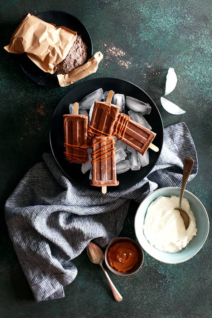 I've revamped my childhood favorite pudding popsicles into these out of this world Dulce de Leche Chocolate Pudding Popsicles!  They couldn't be easier to make and the end result will have you raiding the freezer for more. I've revamped my childhood favorite pudding popsicles into these out of this world Dulce de Leche Chocolate Pudding Popsicles!  They couldn't be easier to make and the end result will have you raiding the freezer for more.