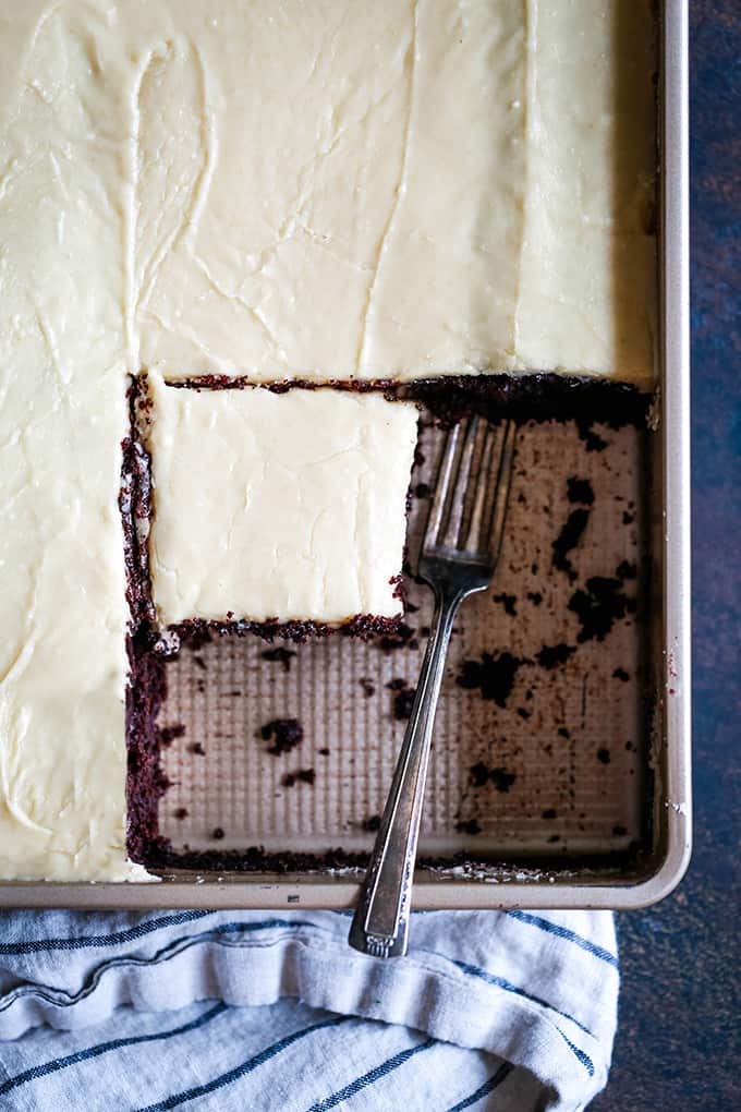 An overhead view of an Eggless Milkless Chocolate Cake with three slices removed.