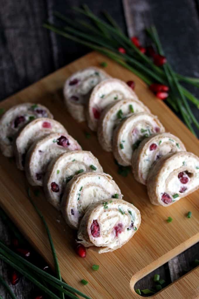 These gorgeous Pomegranate and Feta Pinwheels take just minutes to prepare and are speckled with holiday color thanks to pomegranate arils and chives.  These five ingredient appetizers will have you party ready in no time!