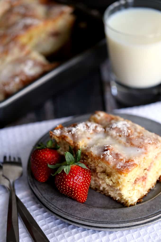 This Strawberries and Cream Coffee Cake will have your family rolling out of their beds and making a beeline for the kitchen in record time. A thick swirl of cream cheese and strawberry jam is sandwiched between two layers of light as air coffee cake. This breakfast treat is then topped with a sugar and butter topping before being baked and then drizzled with a powdered sugar glaze. 