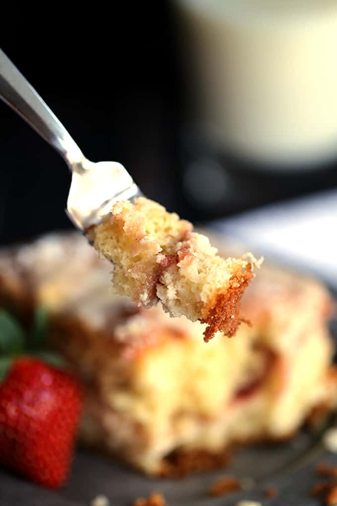 This Strawberries and Cream Coffee Cake will have your family rolling out of their beds and making a beeline for the kitchen in record time. A thick swirl of cream cheese and strawberry jam is sandwiched between two layers of light as air coffee cake. This breakfast treat is then topped with a sugar and butter topping before being baked and then drizzled with a powdered sugar glaze. 