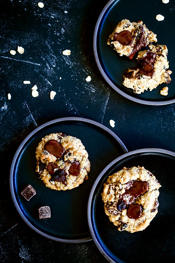 Oatmeal Raisin Chocolate Chip Cookies on three black plates.
