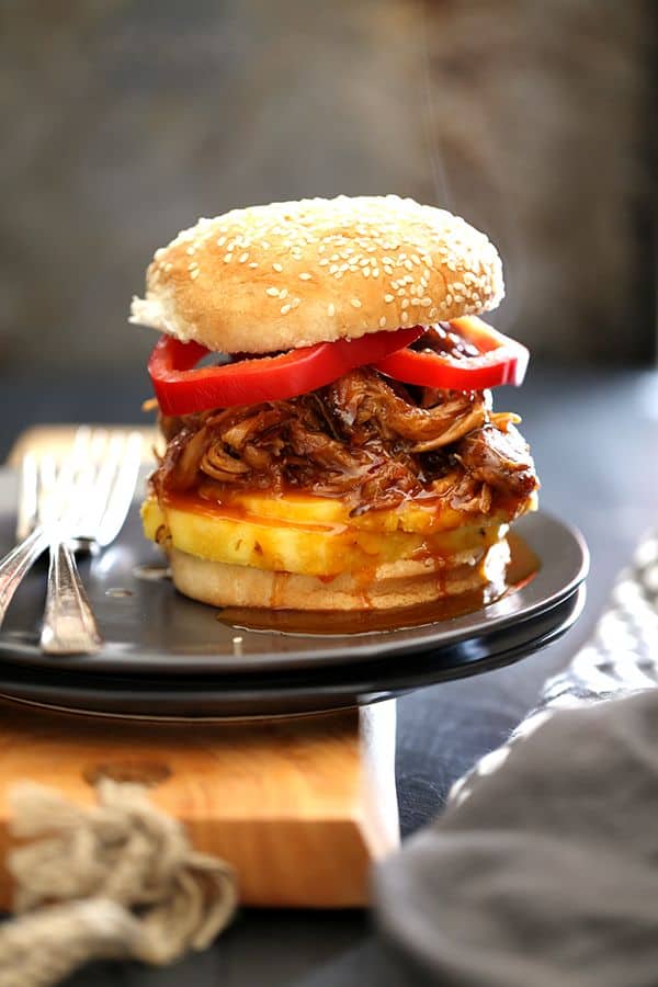 It takes just five minutes and three ingredients to create this sweet and spicy Pineapple and Habanero Slow Cooker Pulled Pork. It's then piled high on a toasted bun and sandwiched between slices of red pepper and fresh pineapple to create the messiest, most delicious pork sandwich that has ever met your lips. 