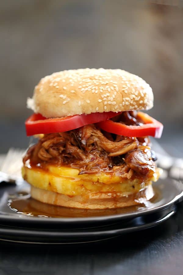 It takes just five minutes and three ingredients to create this sweet and spicy Pineapple and Habanero Slow Cooker Pulled Pork. It's then piled high on a toasted bun and sandwiched between slices of red pepper and fresh pineapple to create the messiest, most delicious pork sandwich that has ever met your lips.
