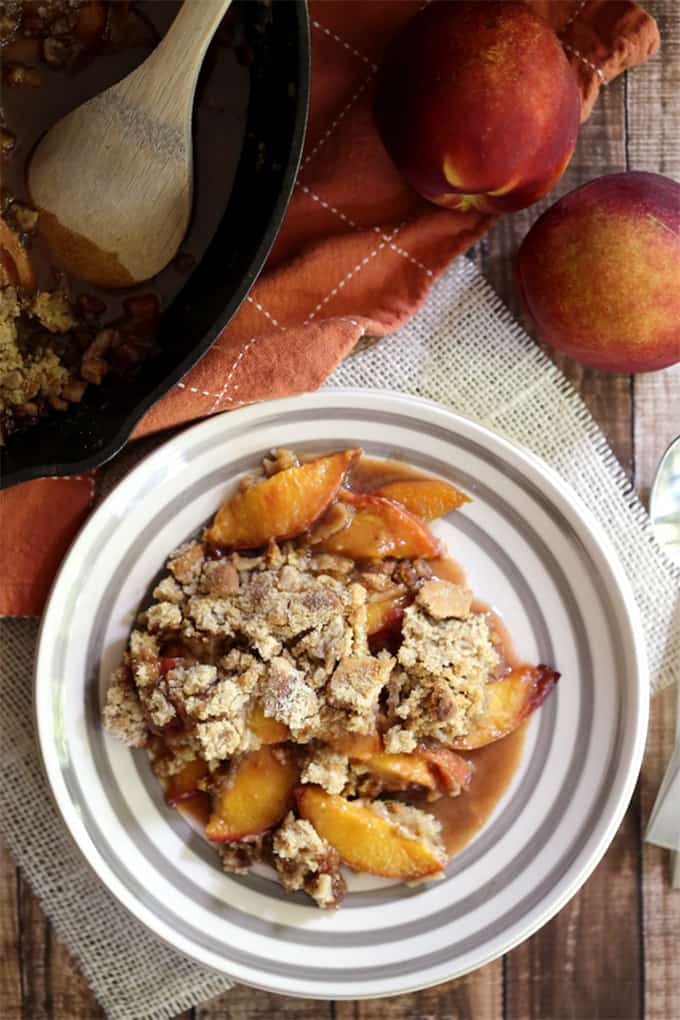 This Iron Skillet Caramel Nectarine Crisp is anything but ordinary, but so incredibly easy!  Slices of fresh nectarines are tossed with allspice and caramel before being topped with a gingersnap cookie crumble.  Topped with a scoop of ice cream, it's dessert perfection.