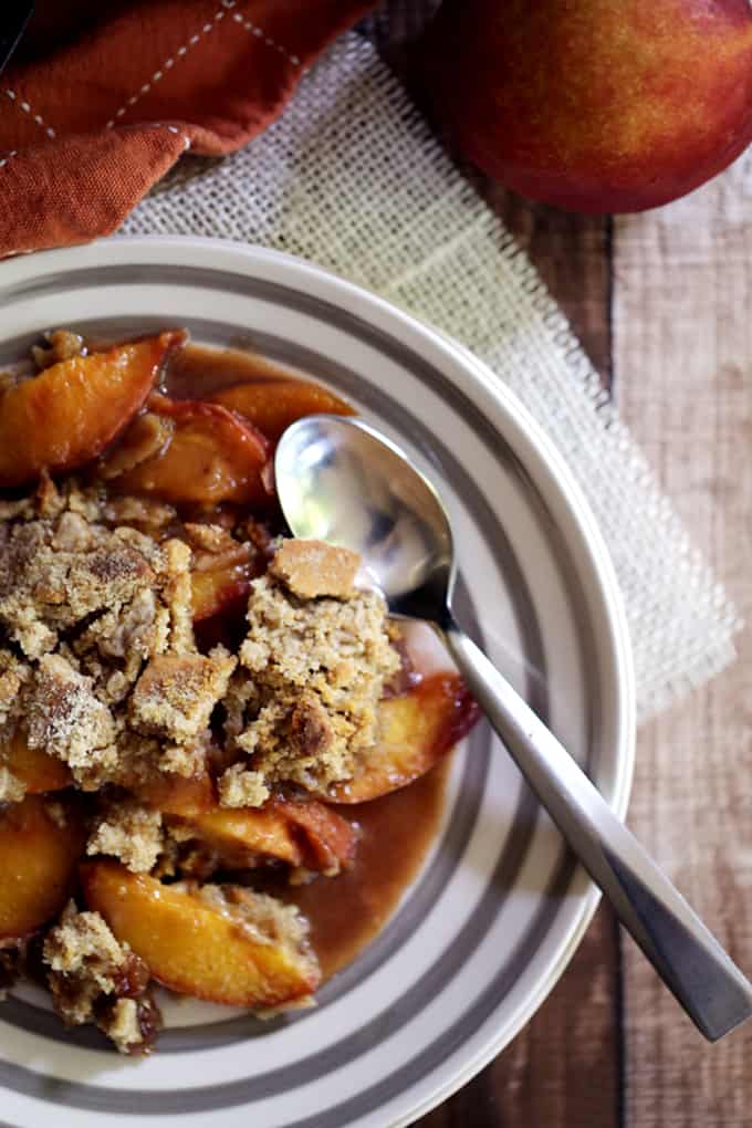 This Iron Skillet Caramel Nectarine Crisp is anything but ordinary, but so incredibly easy!  Slices of fresh nectarines are tossed with allspice and caramel before being topped with a gingersnap cookie crumble.  Topped with a scoop of ice cream, it's dessert perfection.