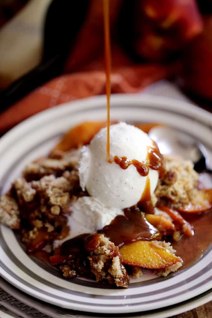 This Iron Skillet Caramel Nectarine Crisp is anything but ordinary, but so incredibly easy!  Slices of fresh nectarines are tossed with allspice and caramel before being topped with a gingersnap cookie crumble.  Topped with a scoop of ice cream, it's dessert perfection.