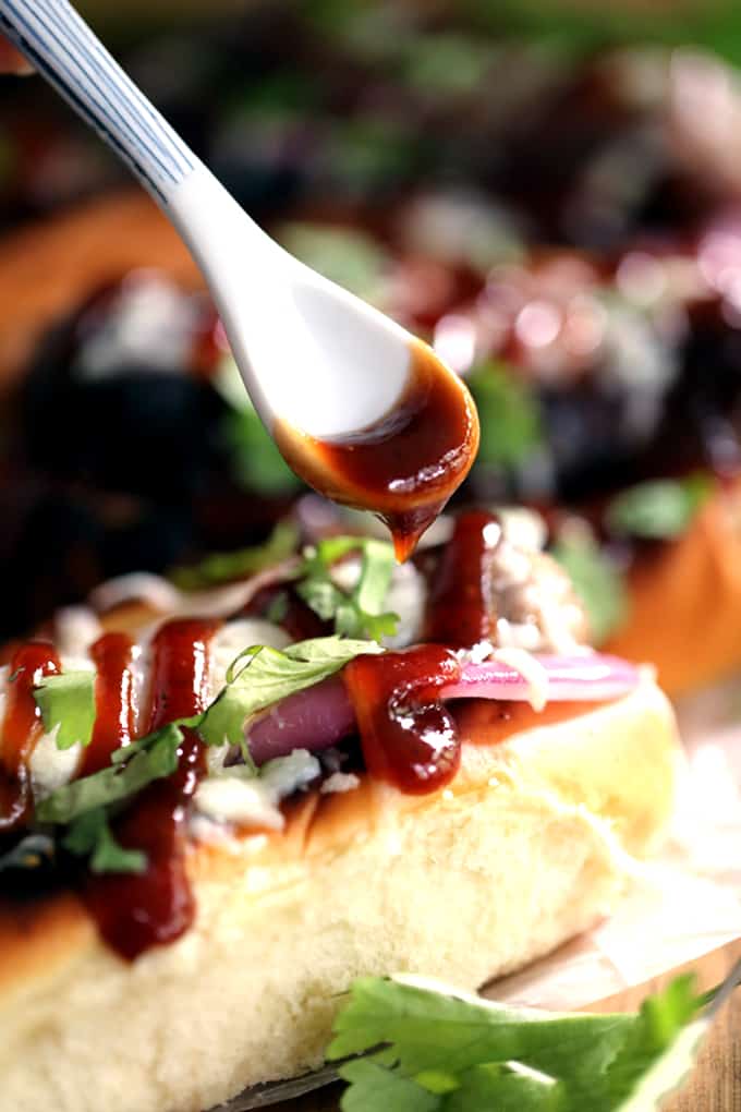 These Barbecue Pizza Bratwursts take all the flavors of your favorite pizza and reinvents them as toppings for your brat. A toasted bun is layered with grilled red onions and bratwurst before being drizzled with barbecue sauce, covered in melted mozzarella cheese and sprinkled with cilantro. 