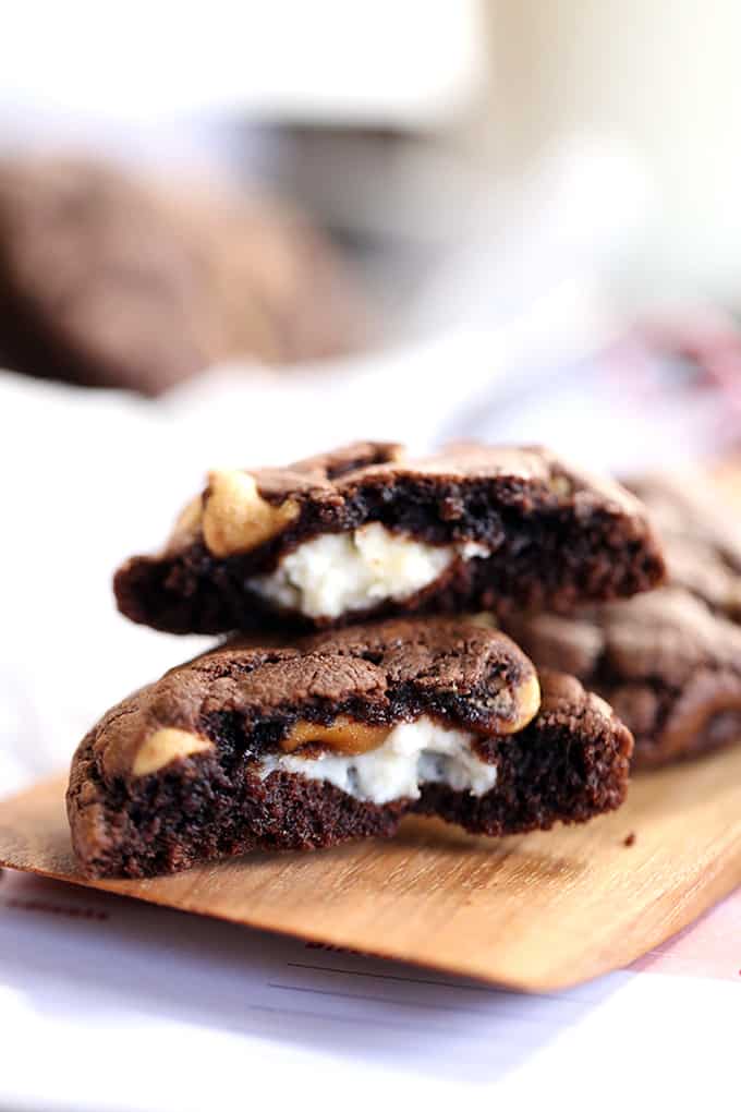 Decadent, almost brownie like, chocolate cookies are studded with peanut butter chips before being stuffed with a rich, cheesecake filling.  These Cheesecake Stuffed Chocolate Peanut Butter Cookies are sure to disappear from your cookie jar at record speed.