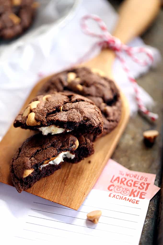 Decadent, almost brownie like, chocolate cookies are studded with peanut butter chips before being stuffed with a rich, cheesecake filling.  These Cheesecake Stuffed Chocolate Peanut Butter Cookies are sure to disappear from your cookie jar at record speed.