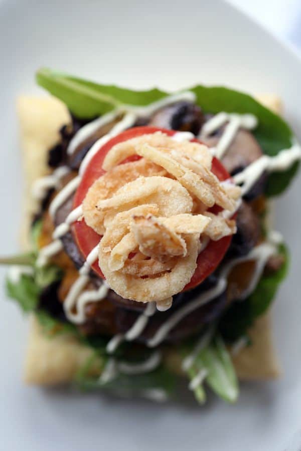 Sure, these Beef Wellington Burgers aren't meant to be handheld but they do welcome a side of fries with open arms! A puff pastry square is layered with salad greens and cheeseburger spiked with horseradish and Dijon mustard before being topped with mushrooms, tomato, french fried onions and a horseradish Dijion mayonnaise.