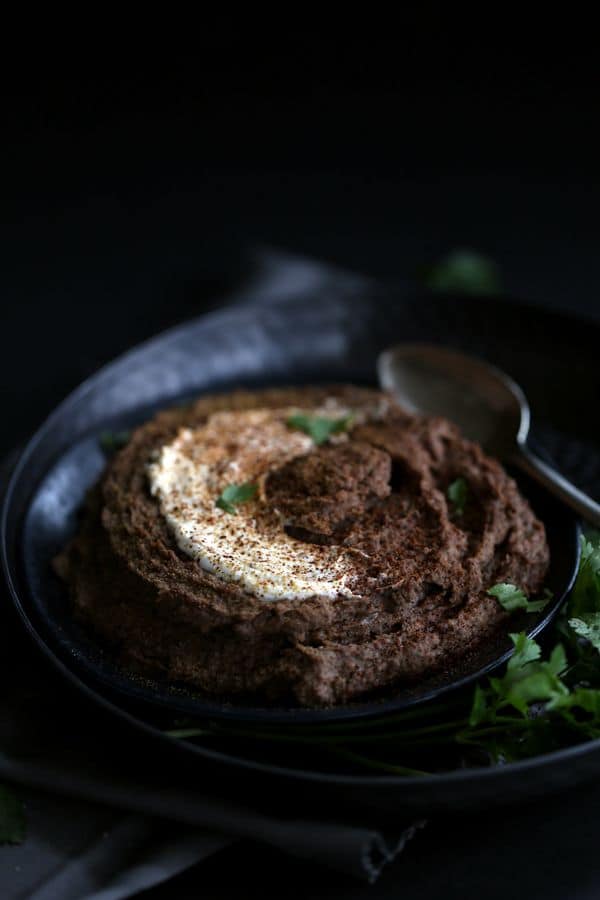 The award for easiest appetizer goes to this Sweet and Spicy Black Bean Hummus. Bid farewell to chickpeas as this hummus gets it's gorgeous earthy color and flavor from pantry staple black beans. All of the ingredients take a whirl in a the bowl of a food processor and emerge as a smooth and creamy hummus ready to enjoy in just 10 minutes.