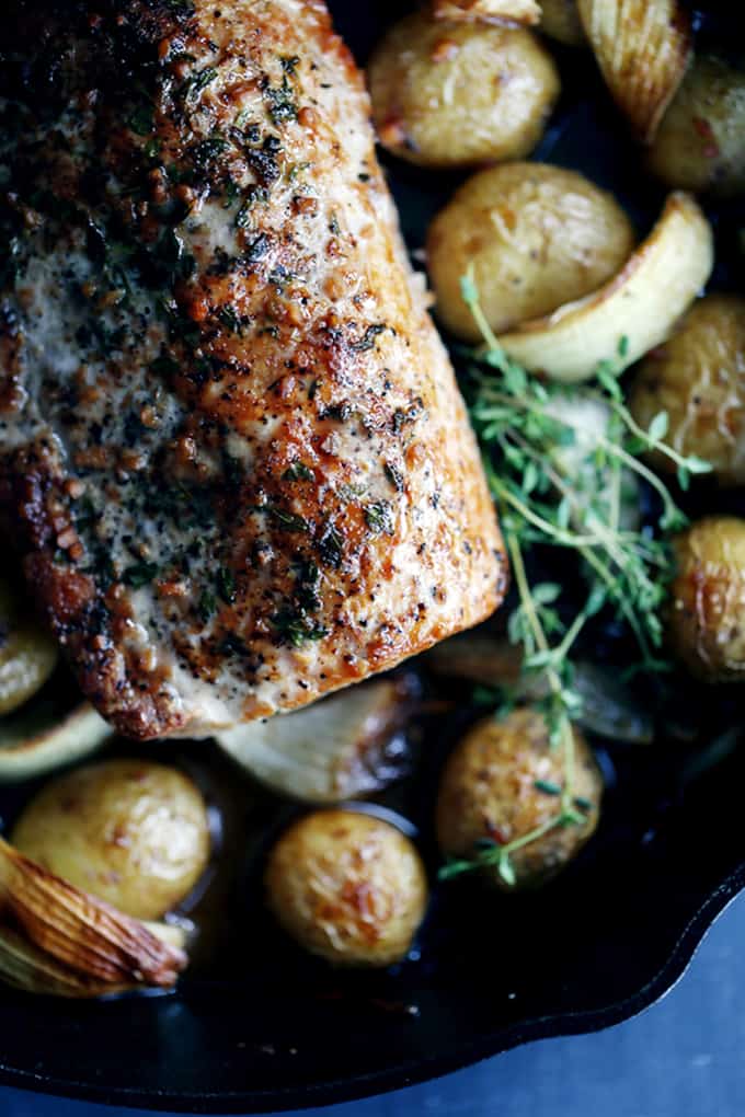 This Thyme Crusted Pork Roast with Soy Caramel Sauce is dressed to impress!  A crust of pepper, salt and thyme envelopes the pork that is then roasted alongside baby Yukon Gold potatoes and onion wedges.  A waterfall of soy caramel sauce is then poured over everything before it's returned to the oven to finish roasting.