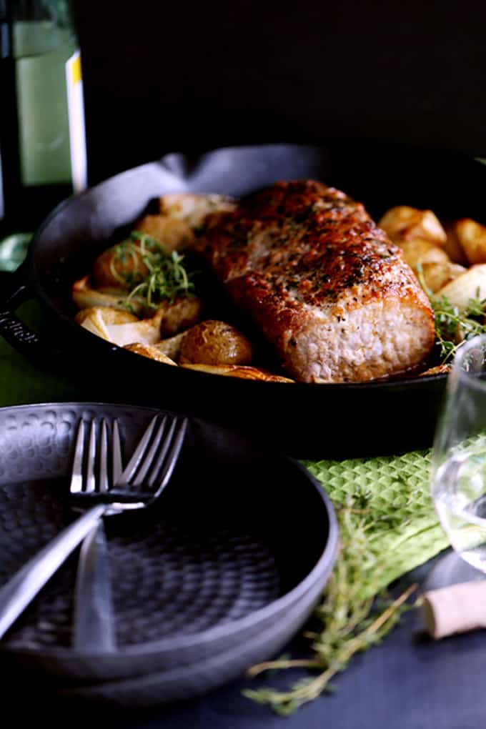 This Thyme Crusted Pork Roast with Soy Caramel Sauce is dressed to impress!  A crust of pepper, salt and thyme envelopes the pork that is then roasted alongside baby Yukon Gold potatoes and onion wedges.  A waterfall of soy caramel sauce is then poured over everything before it's returned to the oven to finish roasting.