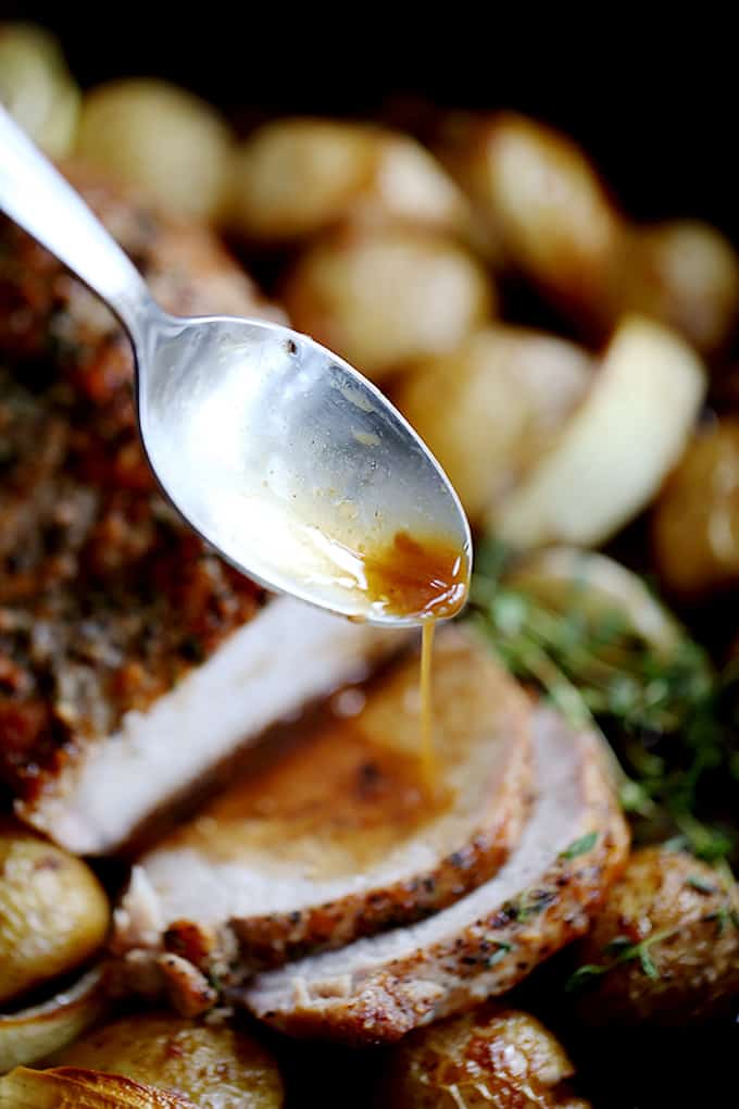 This Thyme Crusted Pork Roast with Soy Caramel Sauce is dressed to impress!  A crust of pepper, salt and thyme envelopes the pork that is then roasted alongside baby Yukon Gold potatoes and onion wedges.  A waterfall of soy caramel sauce is then poured over everything before it's returned to the oven to finish roasting.