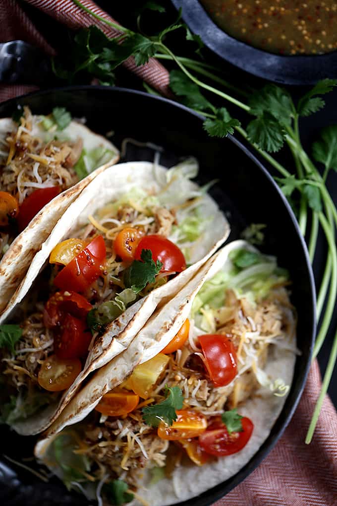 Â These Slow Cooker Honey Mustard Pork Tacos with Candied Bacon couldn't be easier, yet more flavorful. Â Just four ingredients are added to the slow cooker and the sweet and tangy pork that emerges is stuffed into tortillas with candied bacon, lettuce, cheese and tomatoes. Â Your new favorite taco awaits!