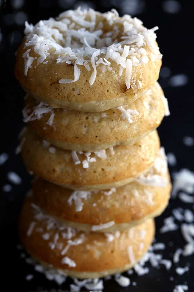 These Coconut Banana Bread Donuts are destined to transport you to your happy place without getting up from your breakfast table. A banana bread batter spiked with coconut is baked to donut perfection before being drizzled with a banana glaze and sprinkled with additional coconut. 