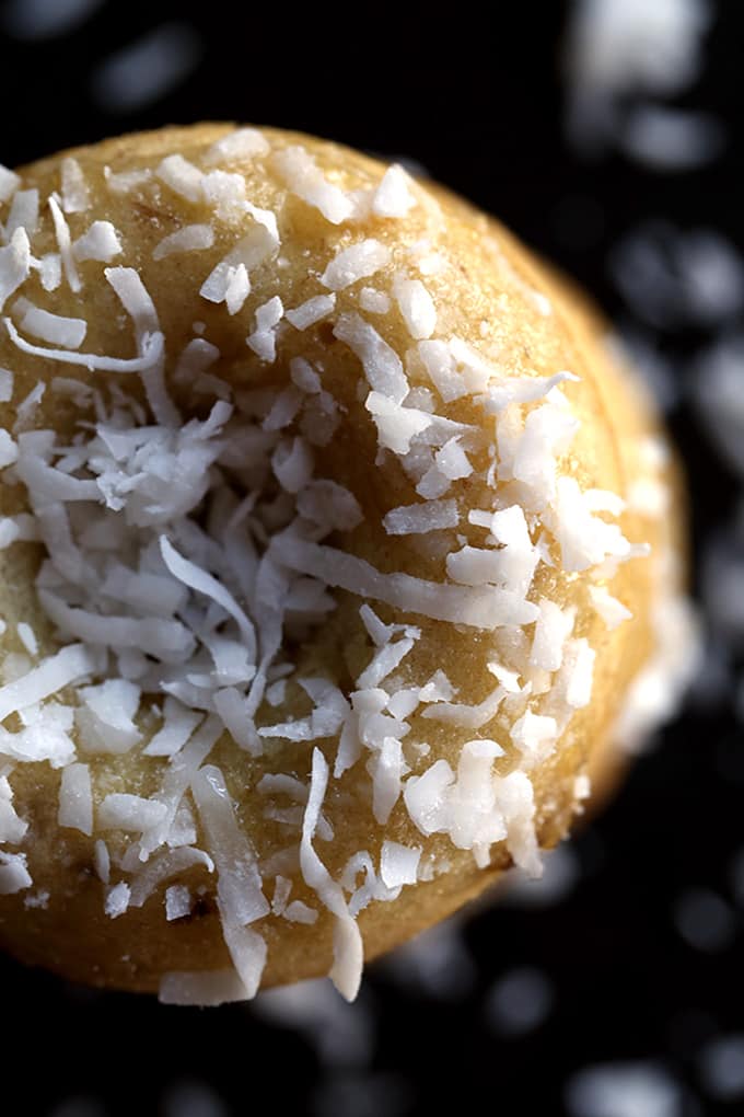 These Coconut Banana Bread Donuts are destined to transport you to your happy place without getting up from your breakfast table. A banana bread batter spiked with coconut is baked to donut perfection before being drizzled with a banana glaze and sprinkled with additional coconut. 