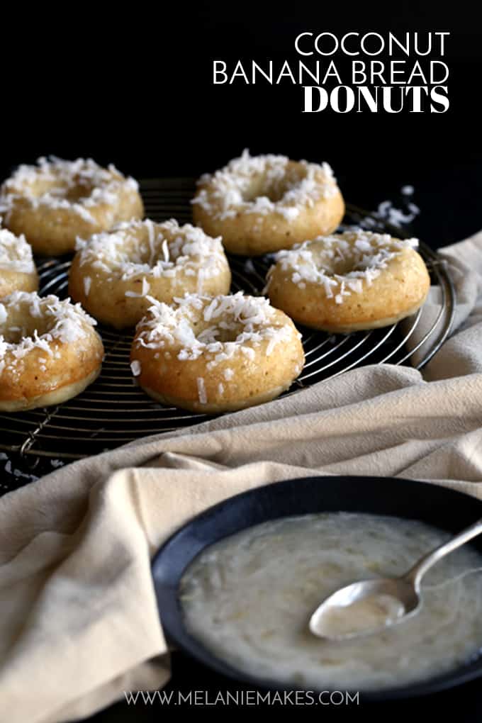 These Coconut Banana Bread Donuts are destined to transport you to your happy place without getting up from your breakfast table. A banana bread batter spiked with coconut is baked to donut perfection before being drizzled with a banana glaze and sprinkled with additional coconut. 