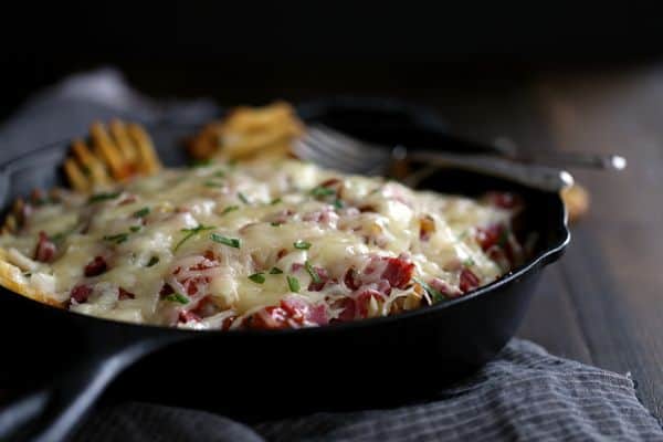 These Reuben Waffle Fries are perfect for St. Patrick's Day, game day or any day when comfort food happens to be on the agenda. Crispy waffle fries are layered with sauerkraut, corned beef, ketchup, relish and garlic horseradish before being smothered with a mountain of Swiss cheese. 
