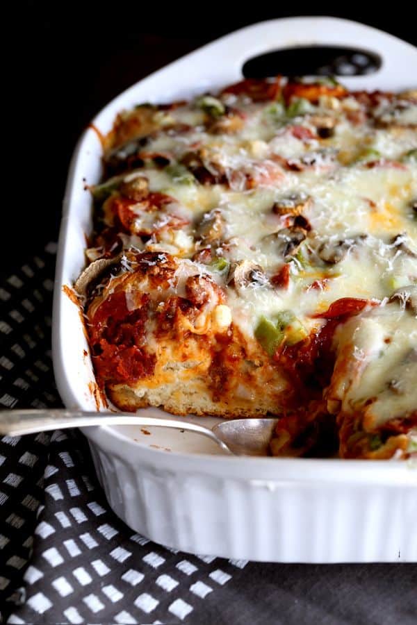 No yeast or rolling dough required - the no-fuss base of this Deep Dish Bubble Pizza comes from refrigerated biscuits! Topped with Italian sausage, pepperoni and vegetables (or your favorite toppings!) before being showered with cheese, this main dish is an absolute family favorite. No yeast or rolling dough required - the no-fuss base of this Deep Dish Bubble Pizza comes from refrigerated biscuits! Topped with Italian sausage, pepperoni and vegetables (or your favorite toppings!) before being showered with cheese, this main dish is an absolute family favorite.