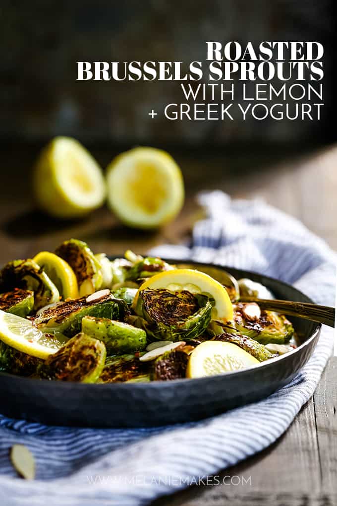 A serving dish of Roasted Brussels Sprouts with Lemon and Greek Yogurt resting on a striped napkin.