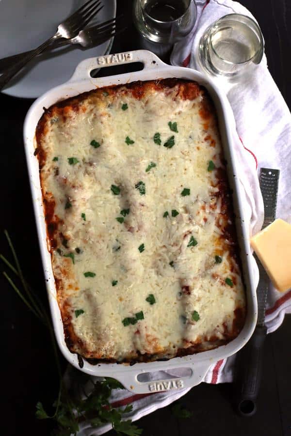 Looking for a new favorite comfort food? Look no further than my Roasted Red Pepper Puttanesca Lasagna Rolls. Single serving lasagna rolls are filled with vegetables, olives, capers and cheese before being bathed in a roasted red pepper sauce and blanketed by two additional layers of cheese and emerge from the oven a pan of melty, bubbly goodness.