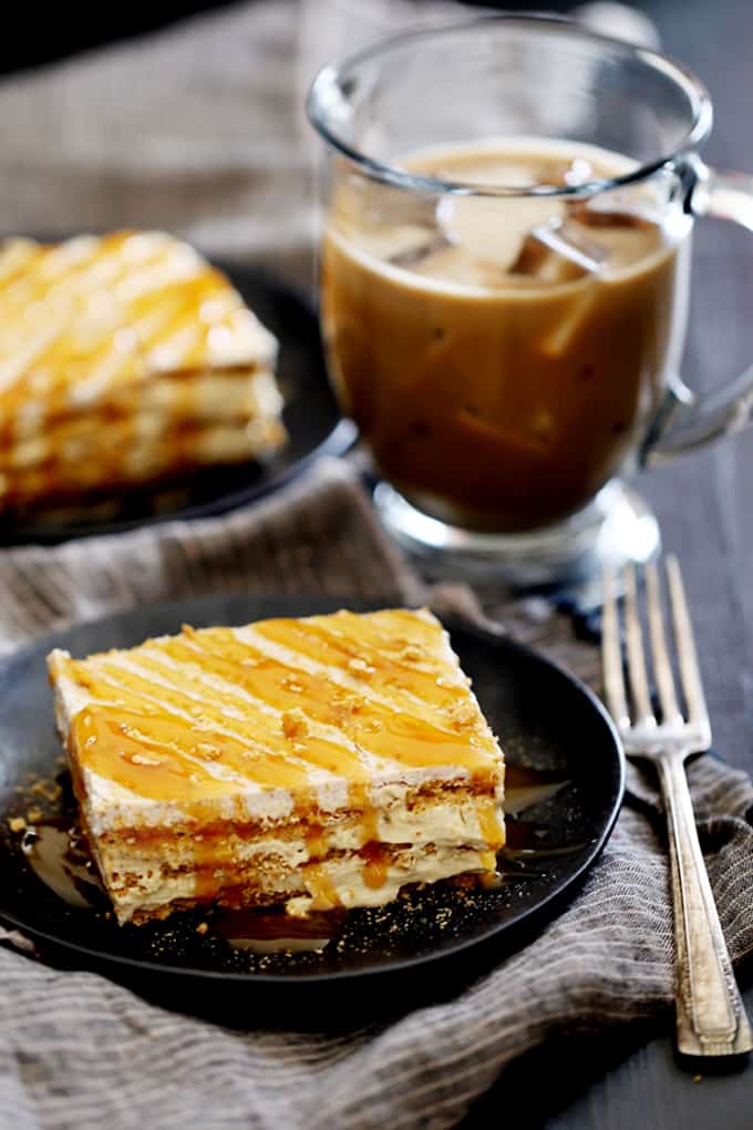 Layers of cinnamon graham crackers, caramel macchiato infused pudding and whipped topping create a rich and decadent No Bake Caramel Macchiato Cake that you can prepare in 10 minutes or less.  Cinnamon flecked vanilla frosting, a shower of graham cracker crumbs and a drizzle of caramel finish this delicious coffee inspired dessert.