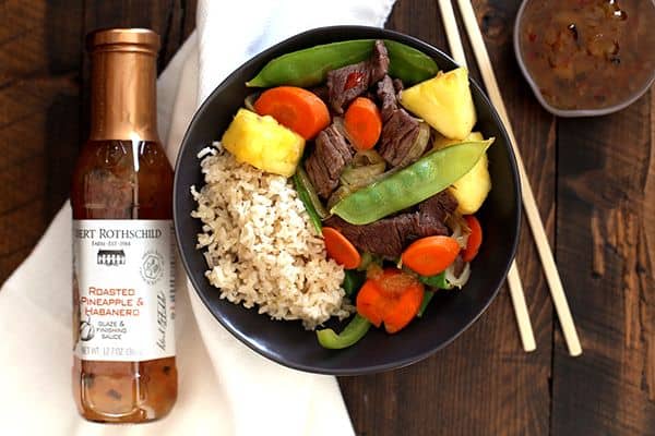 This eight ingredient Pineapple Beef Stir Fry is on the table in just 30 minutes making it perfect for busy weeknights. Sliced pieces of sirloin steak are stir fried with carrots, onions, green peppers, snow peas and pineapple to create a flavorful and colorful main dish.