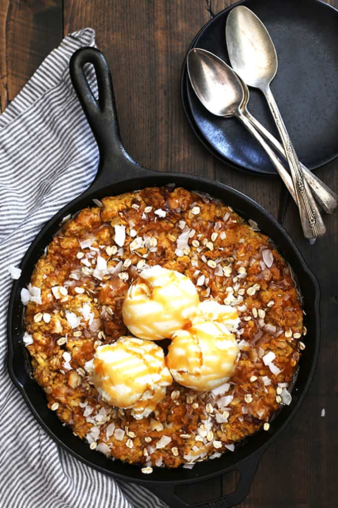 This one dish Coconut Caramel Pumpkin Oatmeal Skillet Cookie takes just 10 minutes to prepare and is the definition of a perfect fall dessert. Coconut flakes and rolled oats are stirred into a pumpkin oatmeal cookie base and baked in the same pan that it was mixed in. It's then topped with additional coconut, oats, caramel sauce and ice cream to create the seasonal dessert of your dreams.