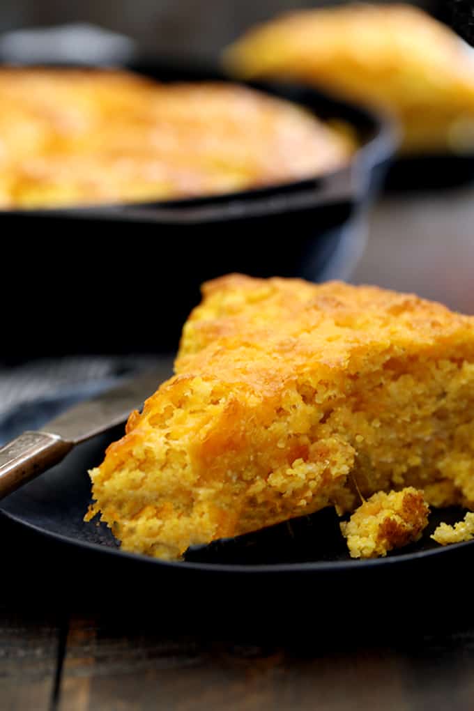 This thick Pumpkin Cream Cheese Skillet Cornbread is the perfect side dish for any fall meal.  Pumpkin, cheddar cheese and cream cheese are spiked with cinnamon and are the standout ingredients of this easy, savory bread.