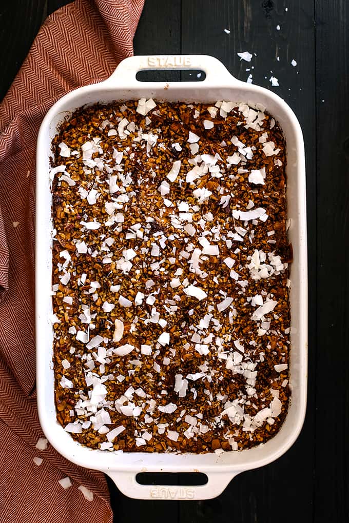 Upside Down German Chocolate Pumpkin Pie in a white baking dish flanked by a napkin.