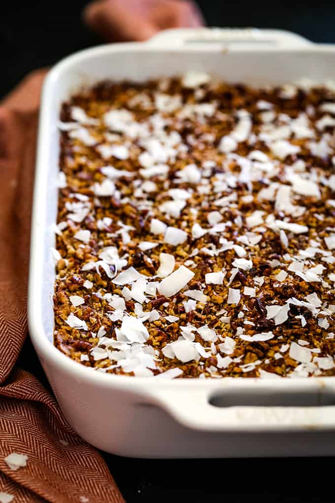 A white ceramic baking dish of German Chocolate Upside Down Pumpkin Pie.