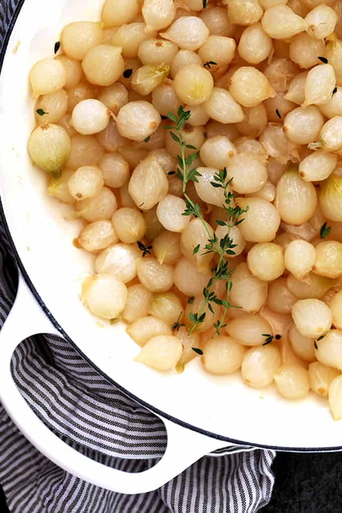 Hands down the easiest holiday side dish you'll ever come across. Â These Glazed Pearl Onions are shellacked with brown sugar and bedazzled with fresh thyme. Â Sure, they may be simple to prepare, but the taste is anything but simple. Â Prepare for them to disappear quickly!