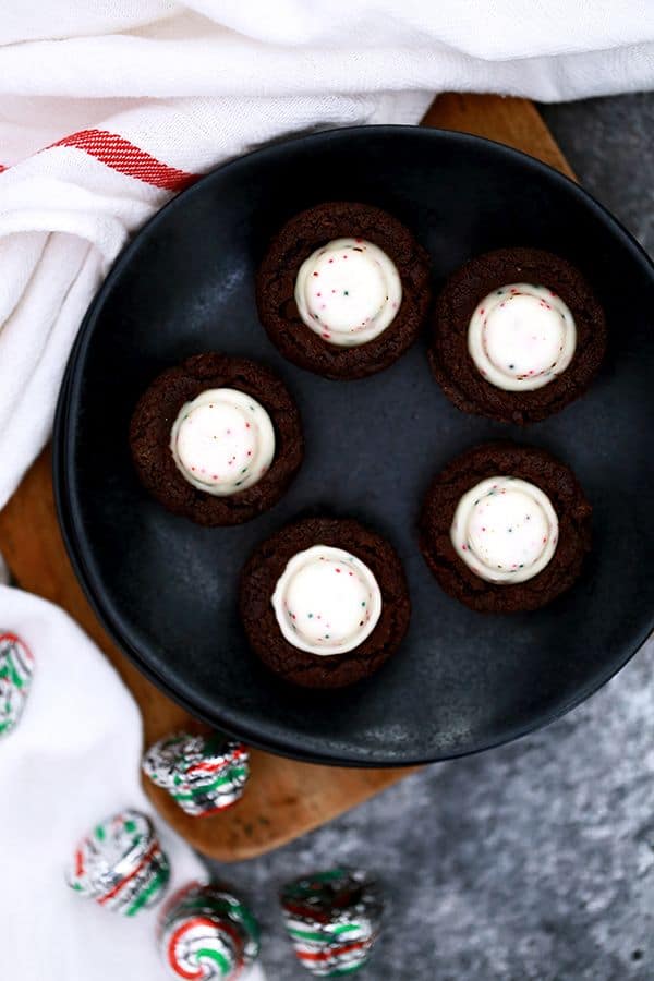 These one bowl Peppermint Bark Brownie Bites are an easy holiday inspired sweet that take just 15 minutes to prepare. Peppermint bark candies stud these deliciously fudgy, one bite chocolate brownie treats.