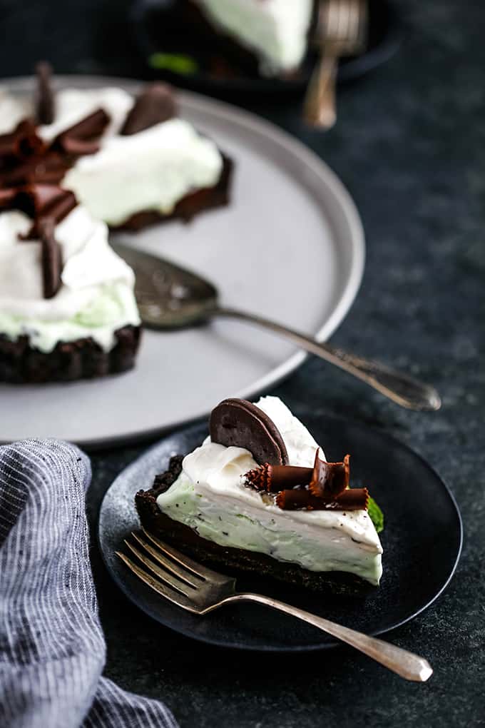 A slice of Grasshopper Ice Cream Tart on a plate with a fork.