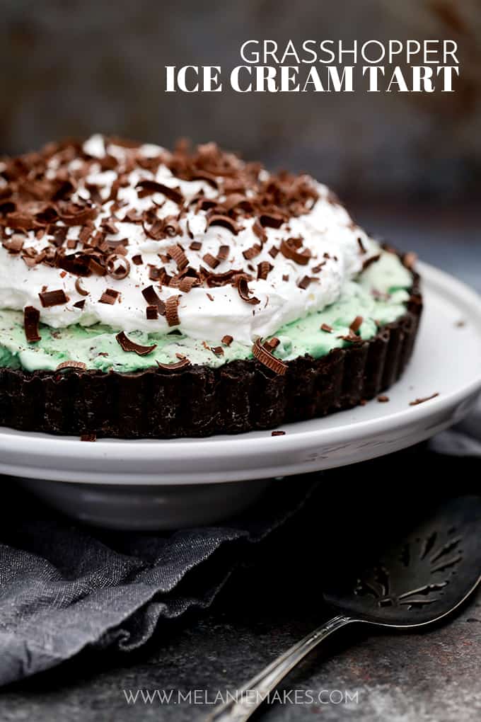 This no bake Grasshopper Ice Cream Tart couldn't be easier or more delicious. A thick Oreo crust is topped with chocolate ganache, mint chocolate chip ice cream and whipped topping before being garnished with dark chocolate curls. So many favorites in every single bite!