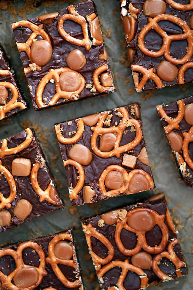 An overhead shot of cut Chocolate Caramel Pretzel Bars on a sheet of parchment.
